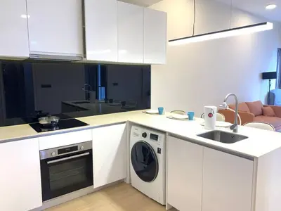a kitchen with a washing machine and a sink at Star Residences KLCC in Kuala Lumpur