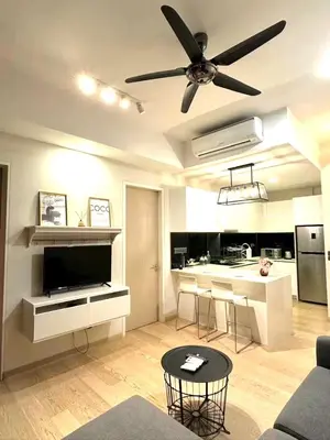 a living room with a ceiling fan and a kitchen at Star Residences KLCC in Kuala Lumpur