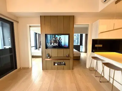 a living room with a television in a cabinet at Star Residences KLCC in Kuala Lumpur