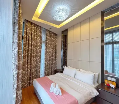 a bedroom with a bed with white towels on it at Dorsett Residences Bukit Bintang in Kuala Lumpur