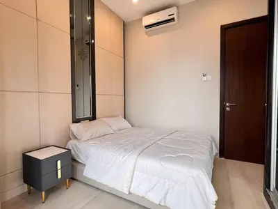 a small bedroom with a bed and a mirror at Dorsett Residences Bukit Bintang in Kuala Lumpur
