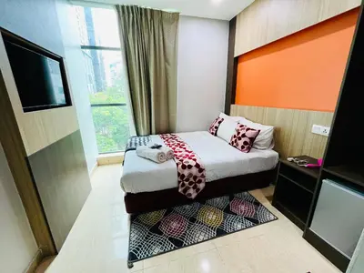 a small room with a bed and a window at Prime Hotel at TRX Tower in Kuala Lumpur