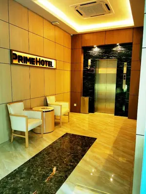 a hotel lobby with chairs and a sign on the wall at Prime Hotel at TRX Tower in Kuala Lumpur