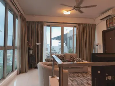 a living room with a couch and a ceiling fan at Penthouse on 34 - The Highest Unit and Best Views in Regalia & Private Rooftop Terrace in Kuala Lumpur
