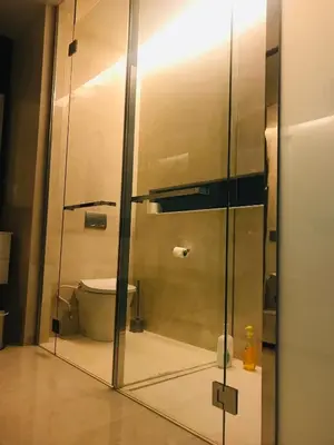 a bathroom with a toilet through a glass door at Tropicana The Residence, KLCC in Kuala Lumpur