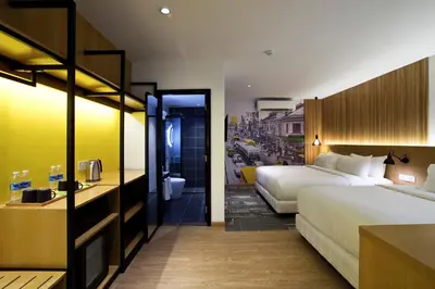 a hotel room with two beds and a bathroom at Indie Hotel Kuala Lumpur in Kuala Lumpur