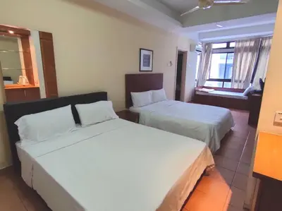 a hotel room with two beds and a window at Pavilion Fahrenheit 88 Bukit Bintang 3 bedrooms in Kuala Lumpur