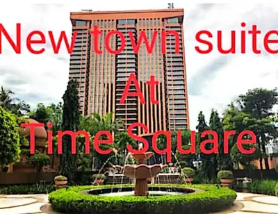 a building with a fountain in front of a building at New Town Suite At Times Square in Kuala Lumpur