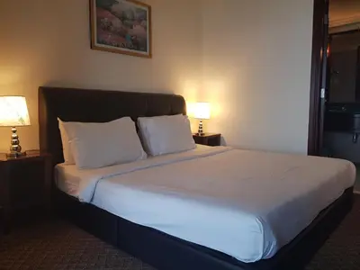 a bedroom with a large bed with white sheets and pillows at New Town Suite At Times Square in Kuala Lumpur