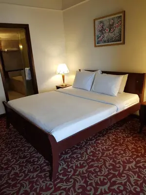 a large bed in a hotel room with a lamp at New Town Suite At Times Square in Kuala Lumpur
