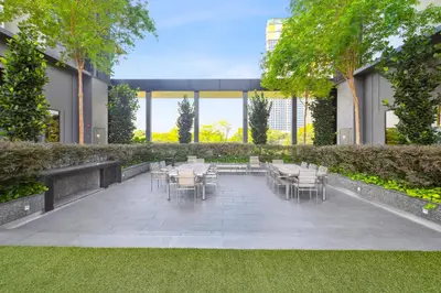 a patio with tables and chairs in a building at Opus Residences by Opus Hospitality in Kuala Lumpur
