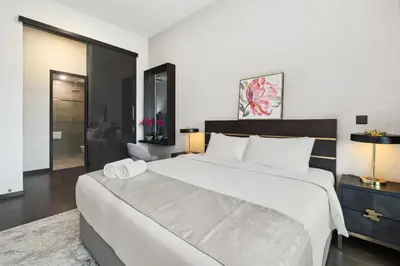 a bedroom with a large white bed in a room at Opus Residences by Opus Hospitality in Kuala Lumpur