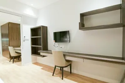 a room with a desk and a tv on a wall at D'Majestic by Plush in Kuala Lumpur