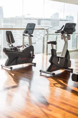 a gym with three exercise bikes in a room at D'Majestic by Plush in Kuala Lumpur