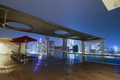 a rooftop patio with a view of a city skyline at D'Majestic by Plush in Kuala Lumpur