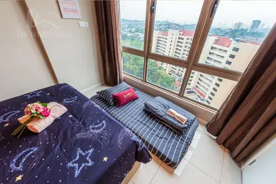 a table with flowers on it in a room with windows at Dorsett Residences Sri Hartamas in Kuala Lumpur
