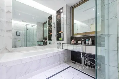 a bathroom with a tub and a large mirror at Dorsett Residences Sri Hartamas in Kuala Lumpur