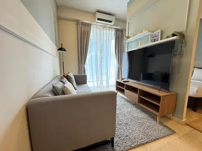 a living room with a couch and a flat screen tv at 231TR by Plush in Kuala Lumpur