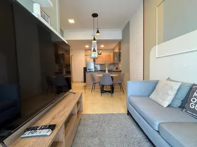 a living room with a couch and a tv at 231TR by Plush in Kuala Lumpur