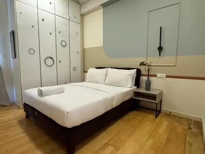 a bedroom with a large bed with white pillows at 231TR by Plush in Kuala Lumpur
