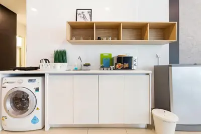 a kitchen with a washer and a washing machine at Arte Plus Kuala Lumpur in Kuala Lumpur