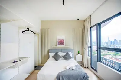 a bedroom with a bed and a large window at Arte Plus Kuala Lumpur in Kuala Lumpur