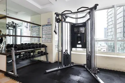 a room with a gym with weights at Parkview Suites KLCC by Airhost in Kuala Lumpur