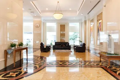 a lobby with couches and chairs in a building at Parkview Suites KLCC by Airhost in Kuala Lumpur