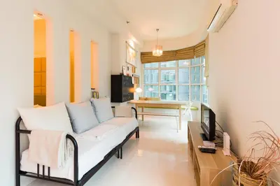 a living room with a white couch and a table at Parkview Suites KLCC by Airhost in Kuala Lumpur