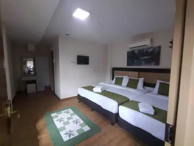 a hotel room with two beds and a couch at Yeob Bay hotel Ampang in Ampang