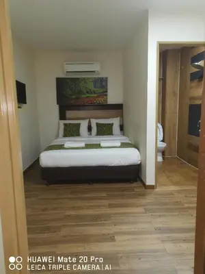 a bedroom with a large bed and a bathroom at Yeob Bay hotel Ampang in Ampang
