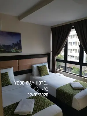 a bedroom with two beds and a large window at Yeob Bay hotel Ampang in Ampang