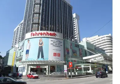 a city street with a building with a large advertisement for a waiter at Bukit Bintang Apartment by Sarah's Lodge @ Fahrenheit88 in Kuala Lumpur