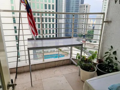a balcony with an american flag and a view of a city at Bukit Bintang Apartment by Sarah's Lodge @ Fahrenheit88 in Kuala Lumpur
