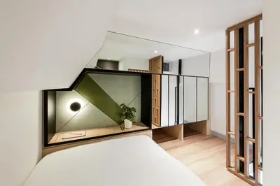 a bedroom with a bed and a glass wall at Komune Living in Kuala Lumpur