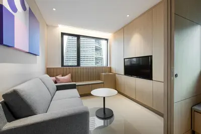 a living room with a couch and a tv at Komune Living in Kuala Lumpur