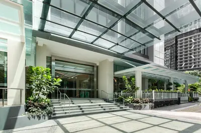 an office building with a glass ceiling and stairs at Komune Living in Kuala Lumpur