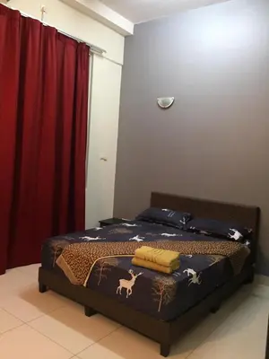 a bedroom with a bed and a red curtain at VUE RESIDENCE SERVICE SUITE - Studio 3 pax in Kuala Lumpur