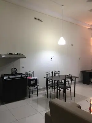 a living room with a table and chairs and a kitchen at VUE RESIDENCE SERVICE SUITE - Studio 3 pax in Kuala Lumpur