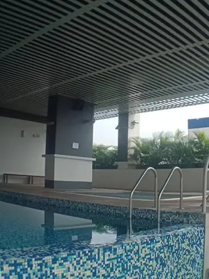 a swimming pool in a building next to a building at VUE RESIDENCE SERVICE SUITE - Studio 3 pax in Kuala Lumpur