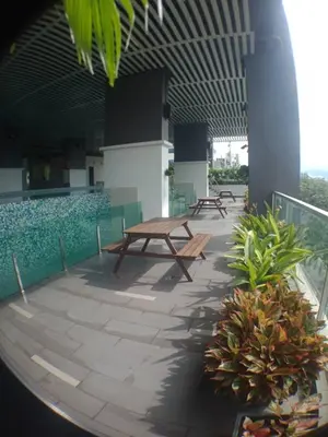 a patio with picnic tables and plants on a building at VUE RESIDENCE SERVICE SUITE - Studio 3 pax in Kuala Lumpur