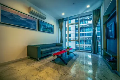 a living room with a couch and a table at La Platinum KLCC in Kuala Lumpur