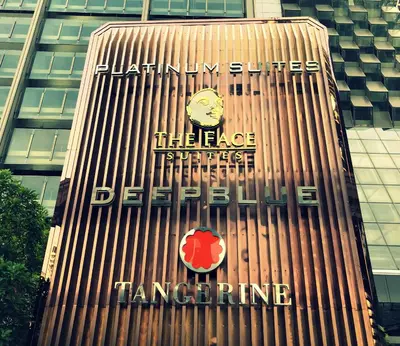 a tall building with a clock on the side of it at La Platinum KLCC in Kuala Lumpur