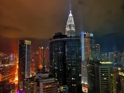 a city skyline at night with a tall building at Yemala Suites at Vortex KLCC in Kuala Lumpur