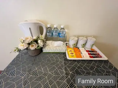 a table with bottles of water and flowers on it at SCC Hotel City Centre in Kuala Lumpur