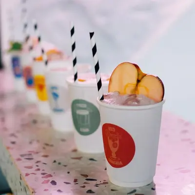 three styrofoam cups with apples in them on a table at MoMo's Kuala Lumpur in Kuala Lumpur