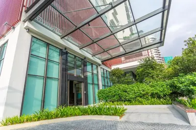 an office building with glass windows and plants at Damai 88 by Moka near KLCC in Kuala Lumpur