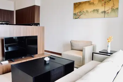 a living room with a couch and a television at Damai 88 by Moka near KLCC in Kuala Lumpur