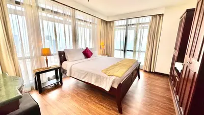 a bedroom with a bed and large windows at RJ Service Suite at Times Square in Kuala Lumpur