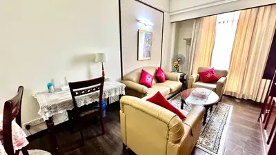 a living room with two couches and a table at RJ Service Suite at Times Square in Kuala Lumpur